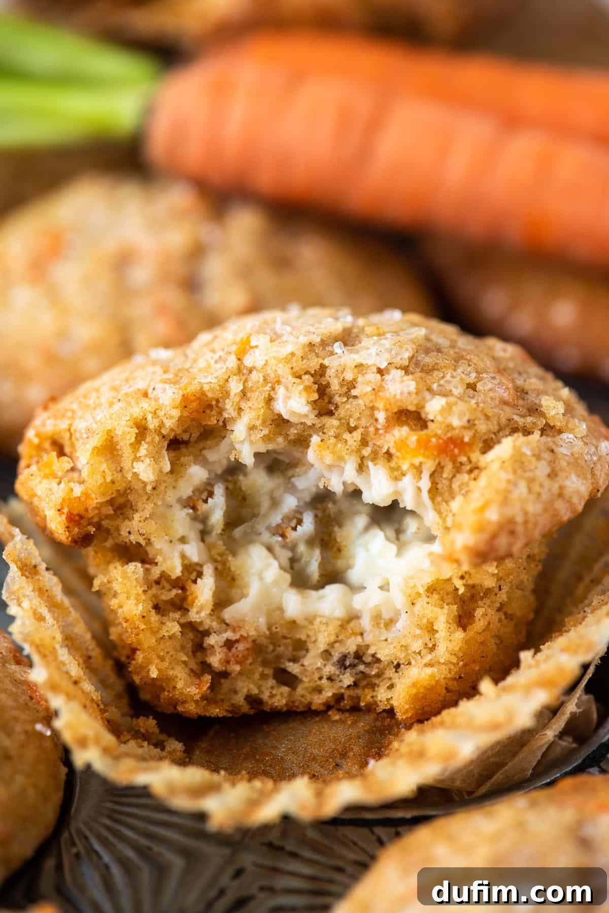 Irresistible Carrot Muffins 3 Carrot cake muffin with bite removed to show cream cheese filling
