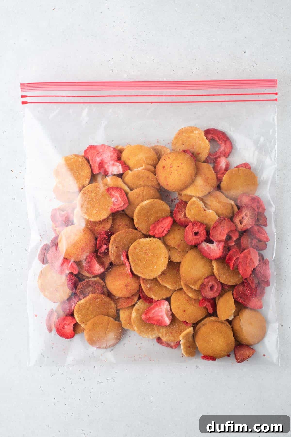 Nilla wafers and freeze dried strawberries in a ziploc bag, ready to be crushed