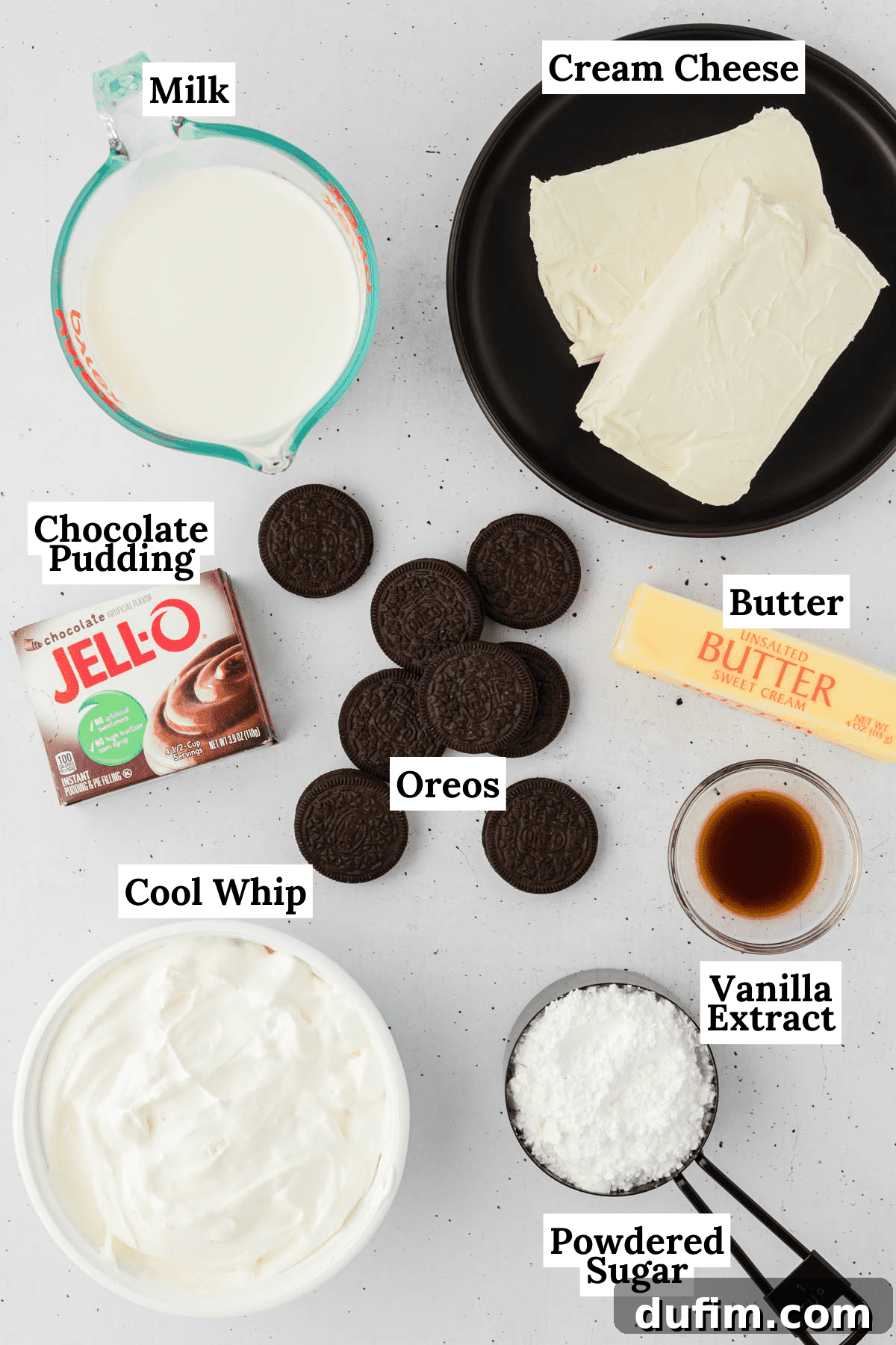 Ultimate Chocolate Lasagna Indulgence 4 All the necessary ingredients for chocolate lasagna are neatly arranged: milk, cream cheese, chocolate instant pudding mix, Oreo cookies, butter, vanilla extract, powdered sugar, and Cool Whip.