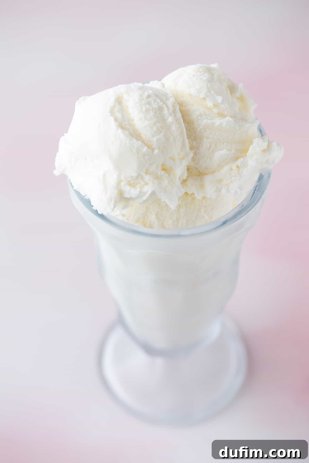 a tall glass cup filled with vanilla ice cream