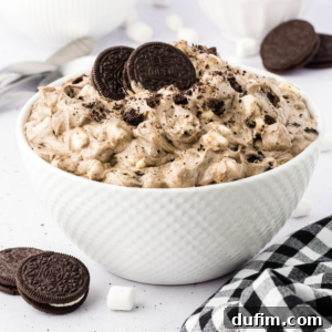 A delicious bowl of creamy Oreo Fluff, ready to be served and enjoyed by everyone.