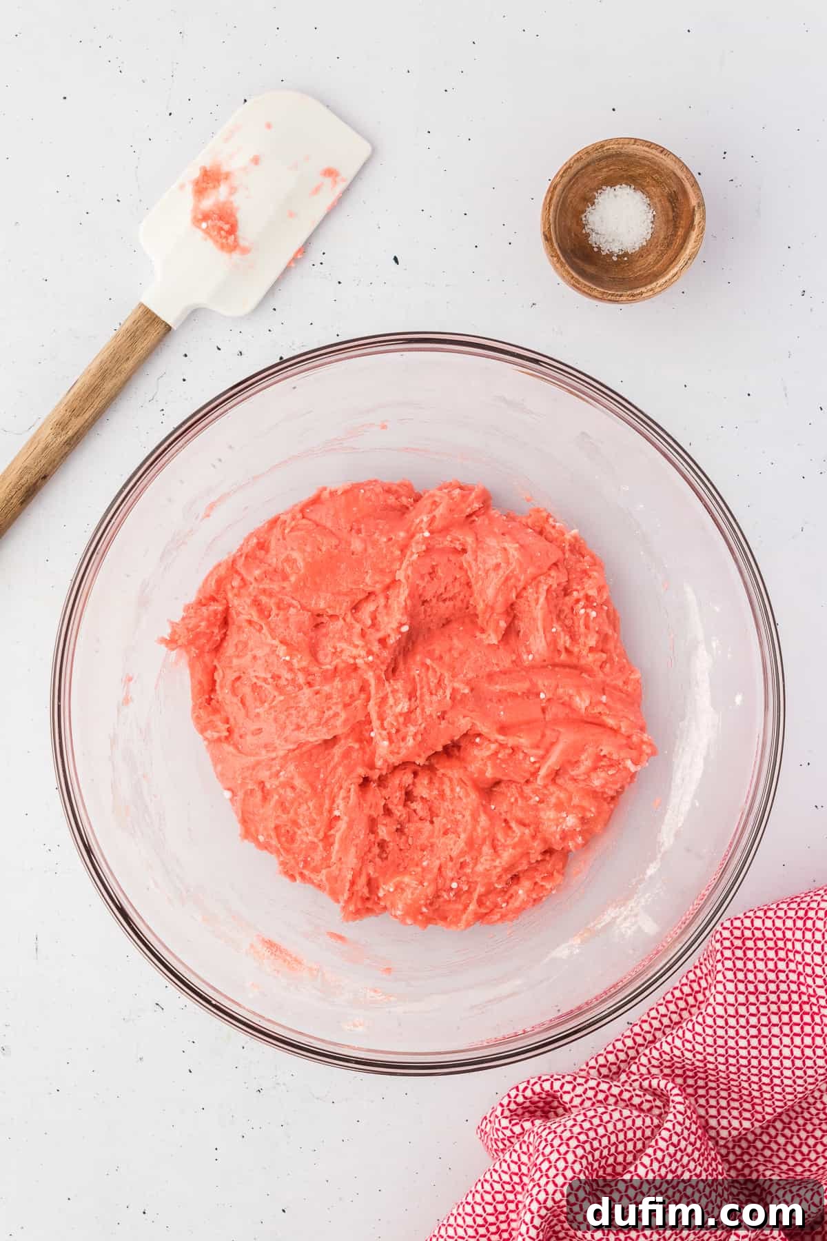 ingredients for strawberry brownies being mixed in a glass bowl