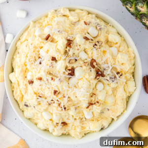 A top-down view of a small bowl of pineapple fluff recipe.