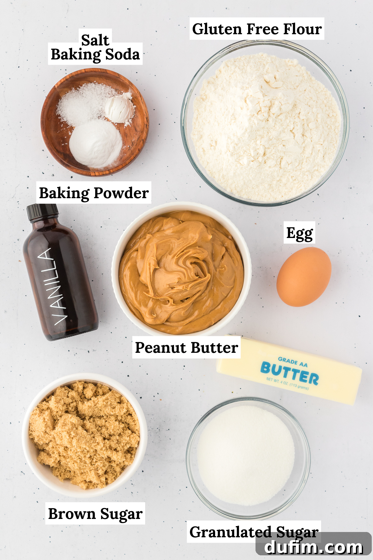 ingredients for gluten free peanut butter cookies including salt, baking soda, gluten free flour, baking powder, vanilla extract, egg, peanut butter, butter, brown sugar and granulated sugar