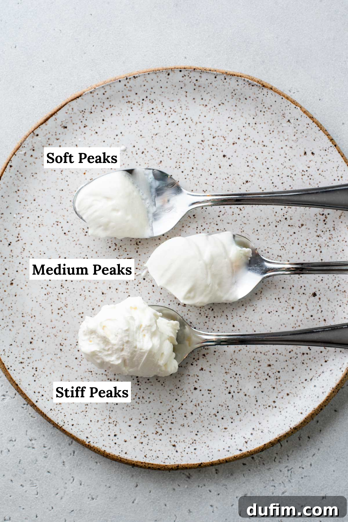 Sweetly Whipped Perfection 11 spoons of whipped cream on a plate with labels showing the different types of peaks: soft peaks, medium peaks, and stiff peaks