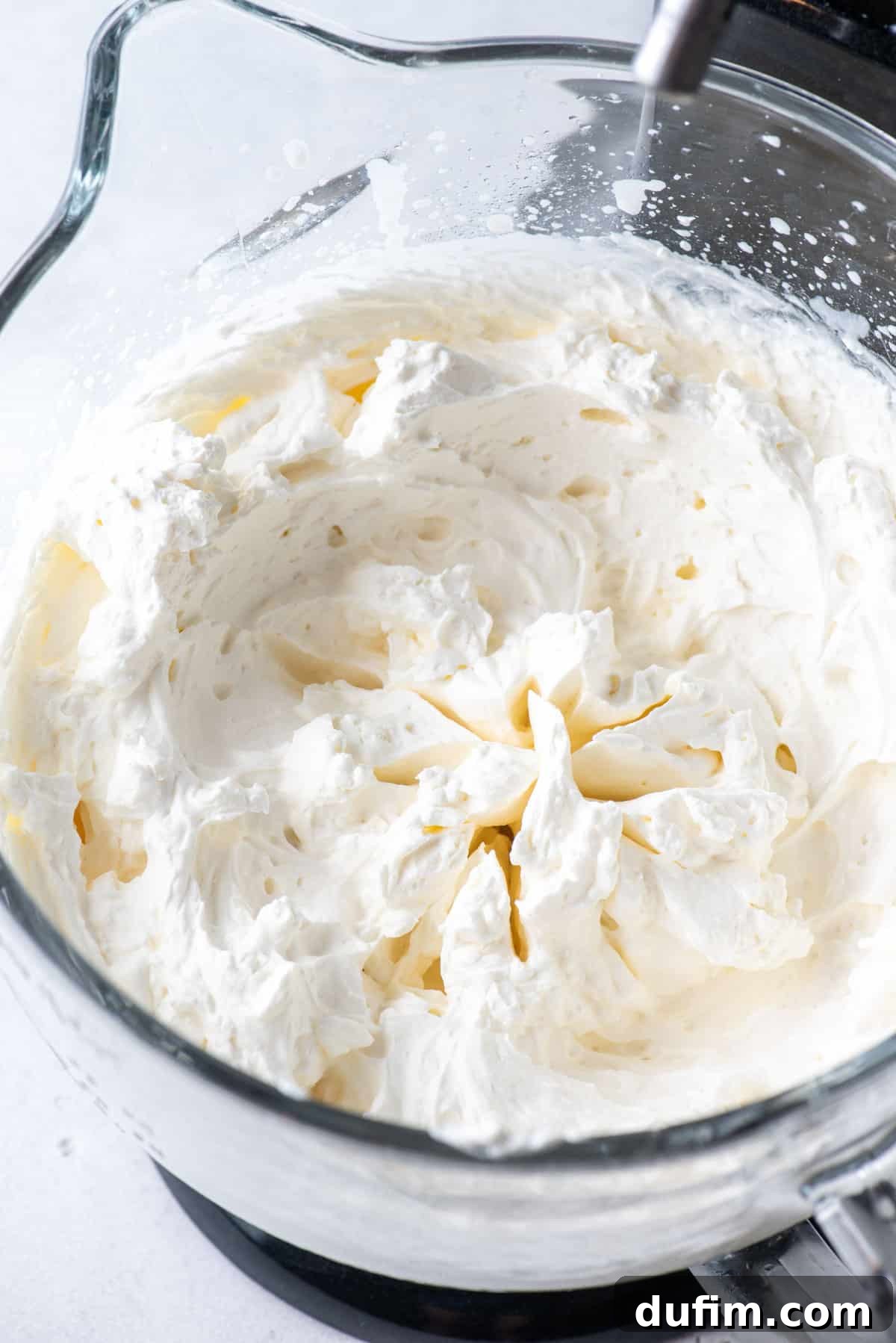 Sweetly Whipped Perfection 5 a close up of a glass bowl full of fresh homemade whipped cream