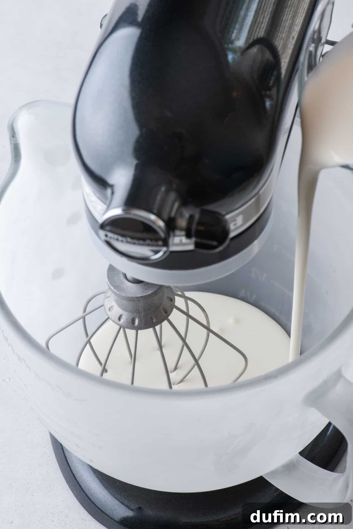 Sweetly Whipped Perfection 8 heavy whipping cream being poured into an electric mixer