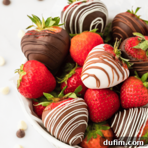 A bowl filled with a delightful mix of chocolate covered strawberries and fresh, whole strawberries, creating an appealing presentation.