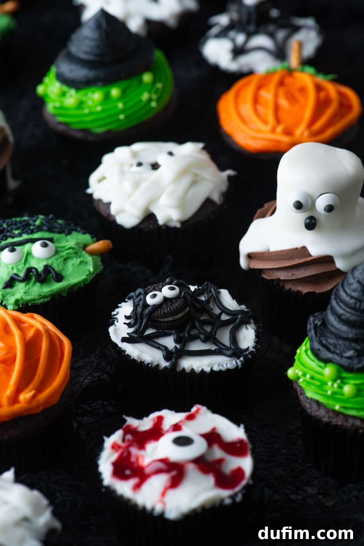 Ghoulishly Good Cupcakes 3 A vibrant display of various Halloween cupcakes, including ghostly figures, bloodshot eyeballs, wrapped mummies, cheerful pumpkins, elegant witch hats, and playful spiders, ready for a Halloween celebration.