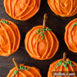 pumpkin patch cupcakes arranged around each other on a wood surface