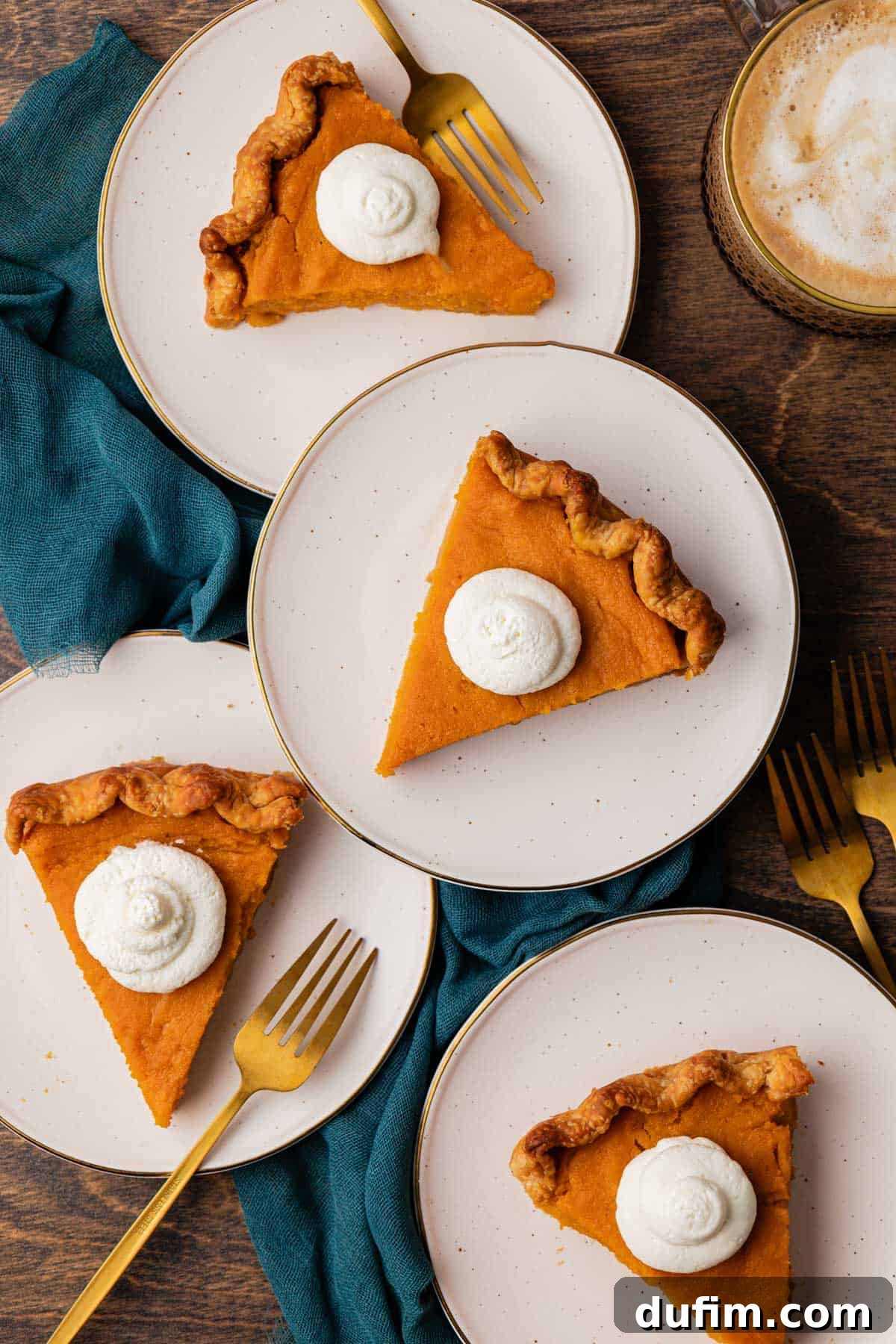 Grandma's Secret Sweet Potato Pie Recipe 5 four small white plates of sweet potato pie on a wood surface with a dark teal towel and forks