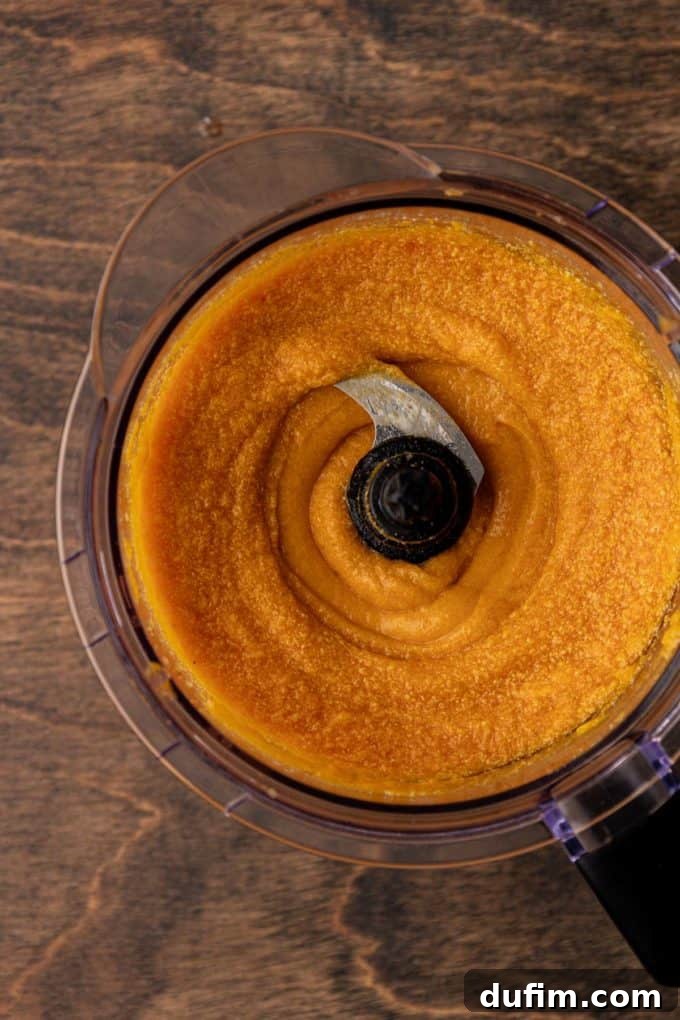 Grandma's Secret Sweet Potato Pie Recipe 10 sweet potato pie filling mixed in a food processor bowl sitting on a wood surface