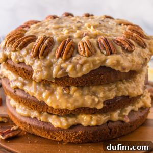A German chocolate cake on a wooden surface, beautifully topped with a ring of whole pecans, serving as the main recipe image.