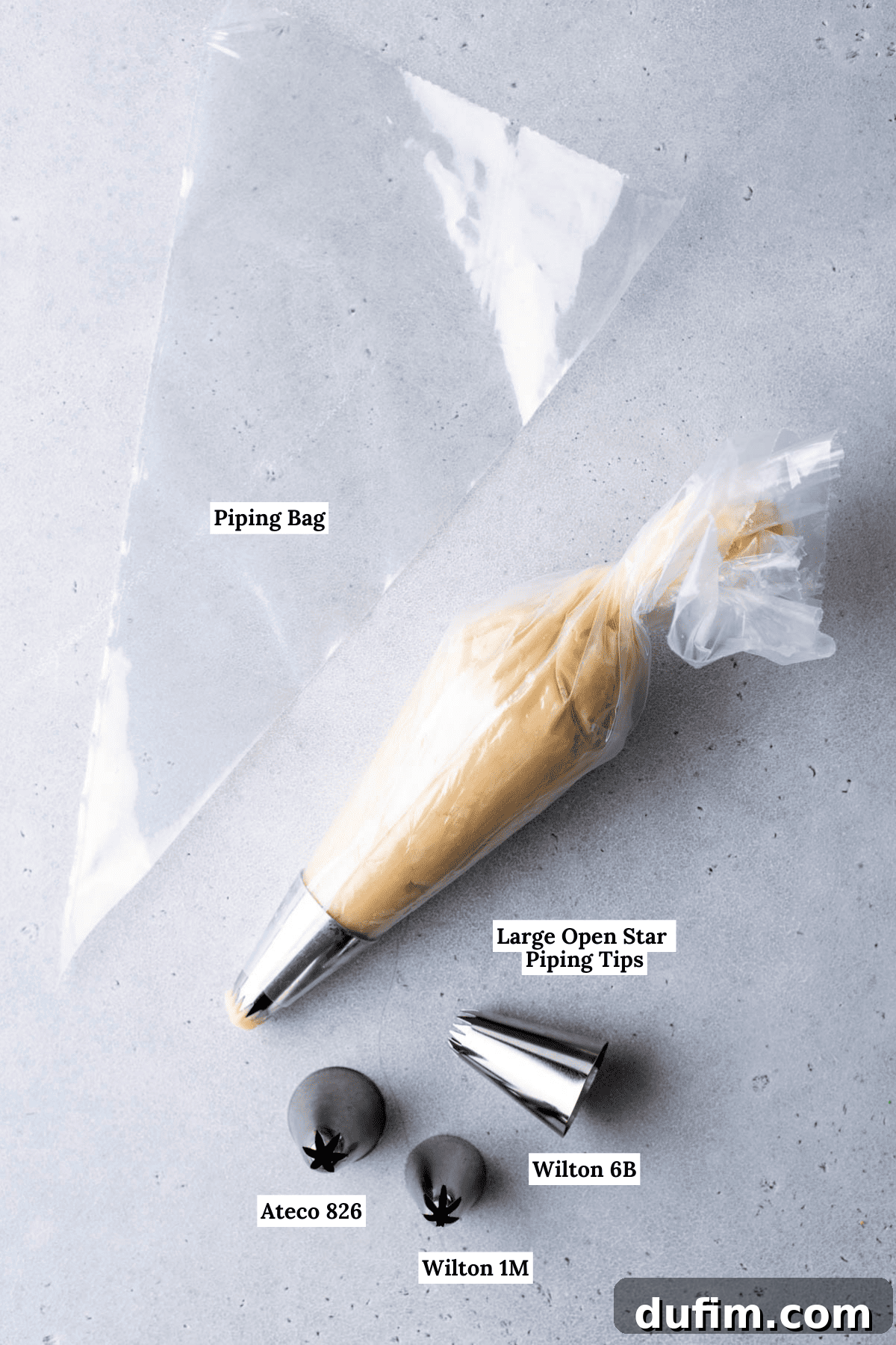 Essential supplies for baking exquisite butter cookies, including a piping bag and a selection of large open star piping tips, specifically Wilton 6B, Wilton 1M, and Ateco 826.