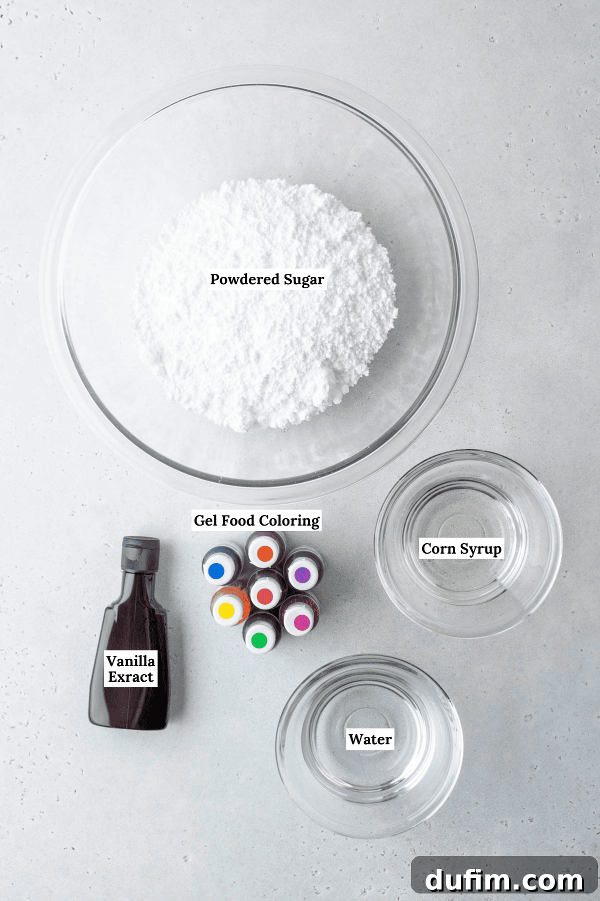 Royal icing ingredients laid out: gel food coloring, powdered sugar, corn syrup, water, and vanilla extract.