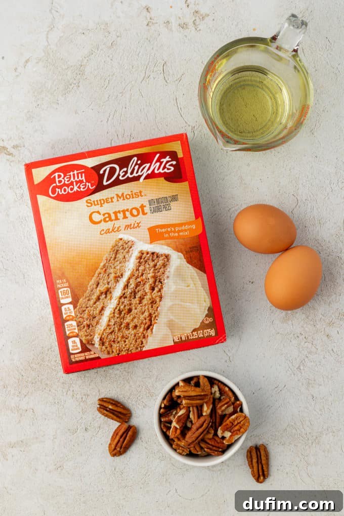Ingredients for warmly spiced carrot cake mix cookies: a box of carrot cake mix, two fresh eggs, crunchy pecans, and vegetable oil, ready for combining to create a delightful treat.