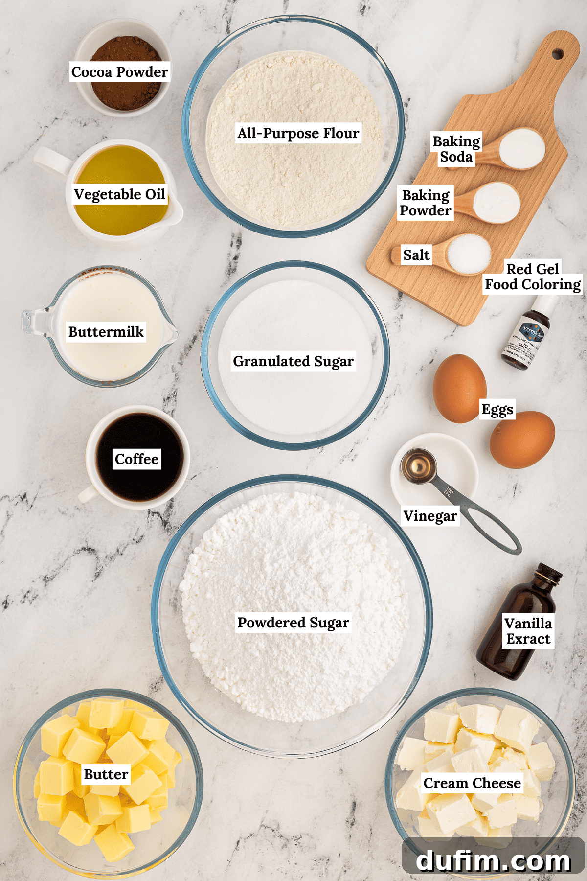 Homemade Red Velvet Cake Perfection 5 A flat lay arrangement of fresh, high-quality ingredients for red velvet cake, including all-purpose flour, Dutch-processed cocoa powder, baking soda, baking powder, salt, granulated sugar, eggs, buttermilk, vegetable oil, vanilla extract, red food coloring, distilled vinegar, instant coffee granules, unsalted butter, powdered sugar, and cream cheese.