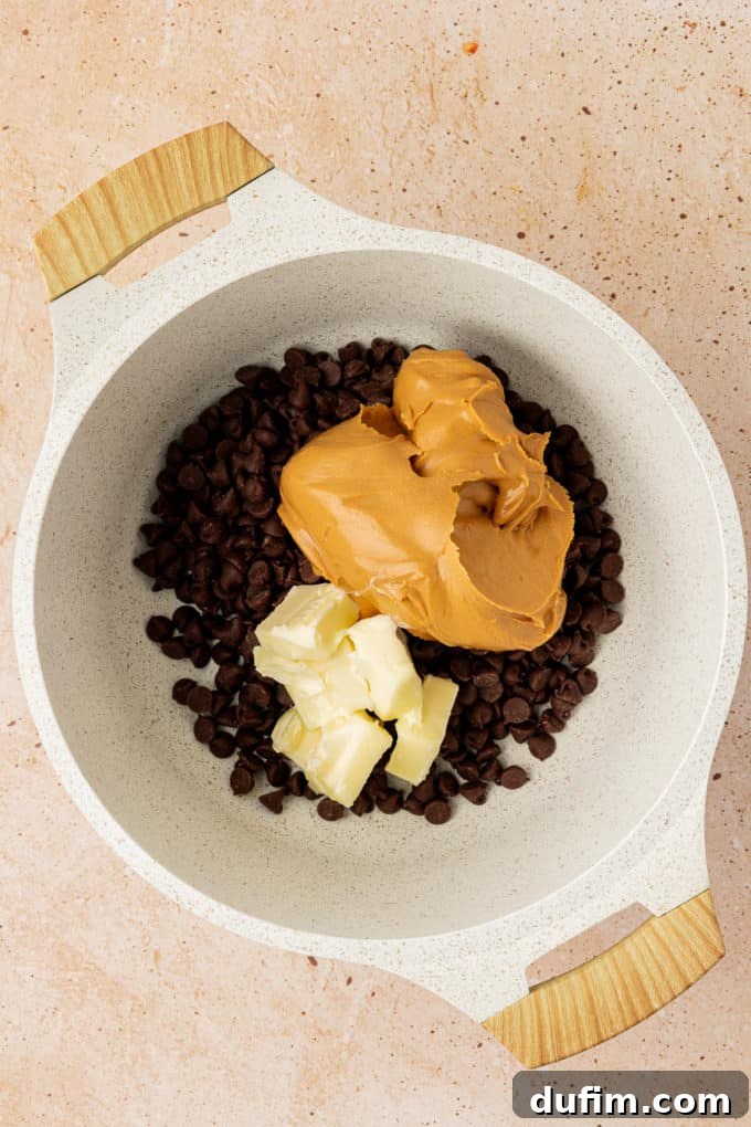 chocolate chips, peanut butter and cubes of butter in a white pot