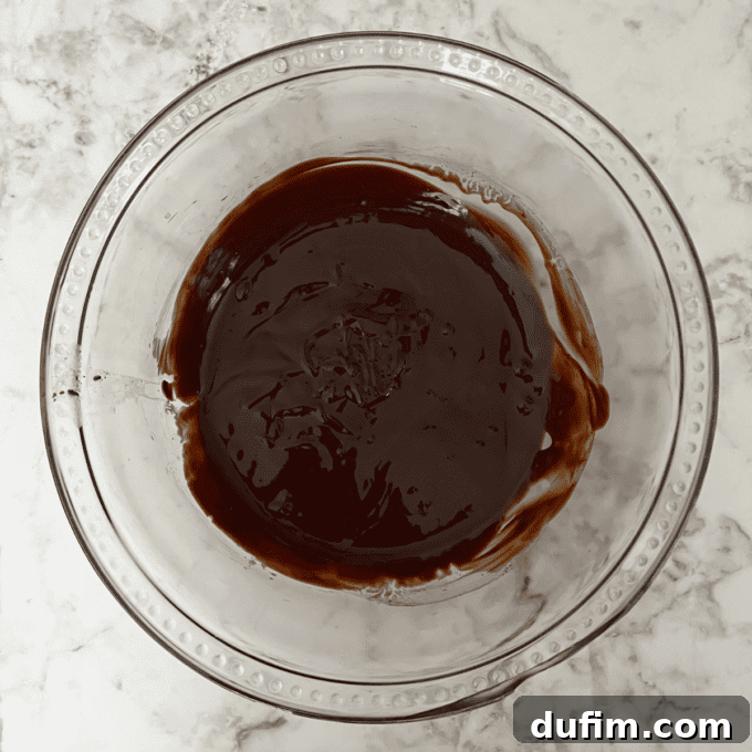 Decadent Flourless Chocolate Cake 9 Melted butter and chocolate chips being stirred