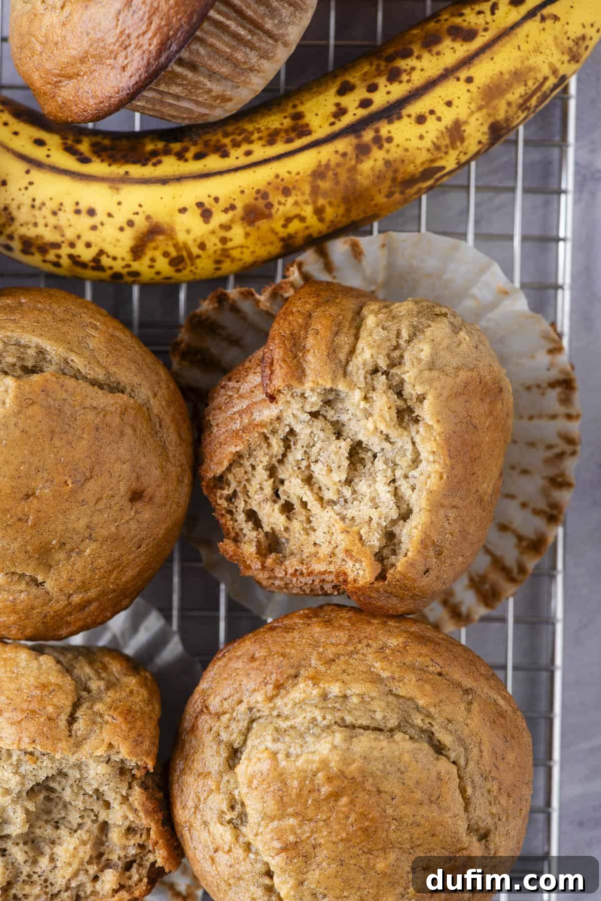 A single healthy banana muffin, beautifully domed and golden brown, on a simple background, highlighting its inviting texture.