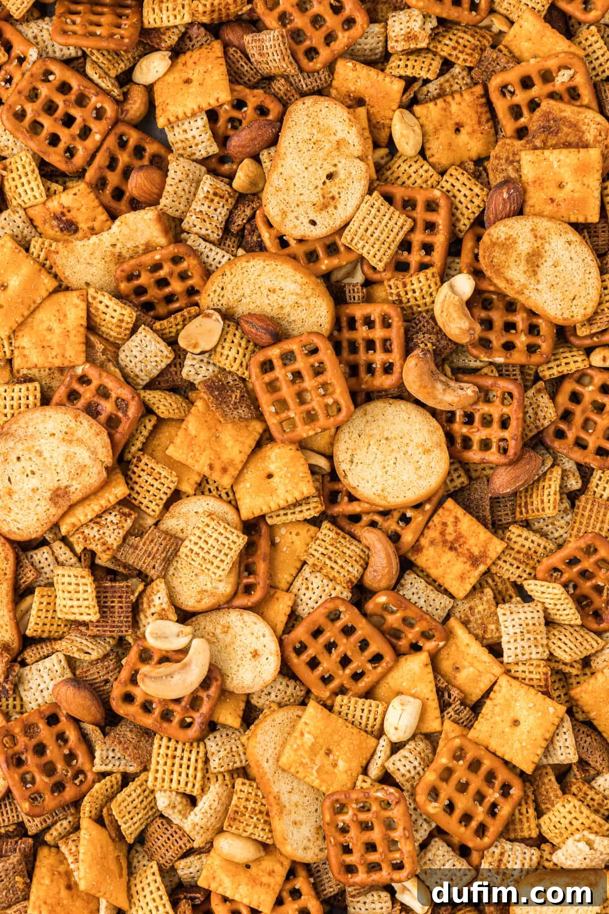 Unlock the Secret to Perfect Chex Mix 15 A close-up view of perfectly seasoned, crispy homemade Chex Mix, showing the individual cereals, nuts, and crackers coated in savory goodness.