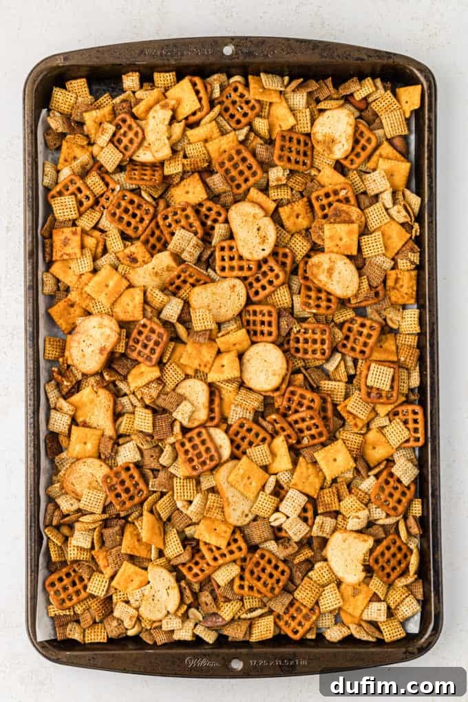 Unlock the Secret to Perfect Chex Mix 10 Another view of a baking sheet full of homemade Chex Mix, highlighting the generous quantity and even spread.
