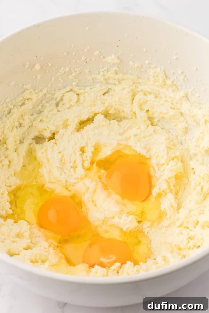 wet ingredients for vanilla bundt cake in a white bowl with eggs on top that haven't been mixed in yet