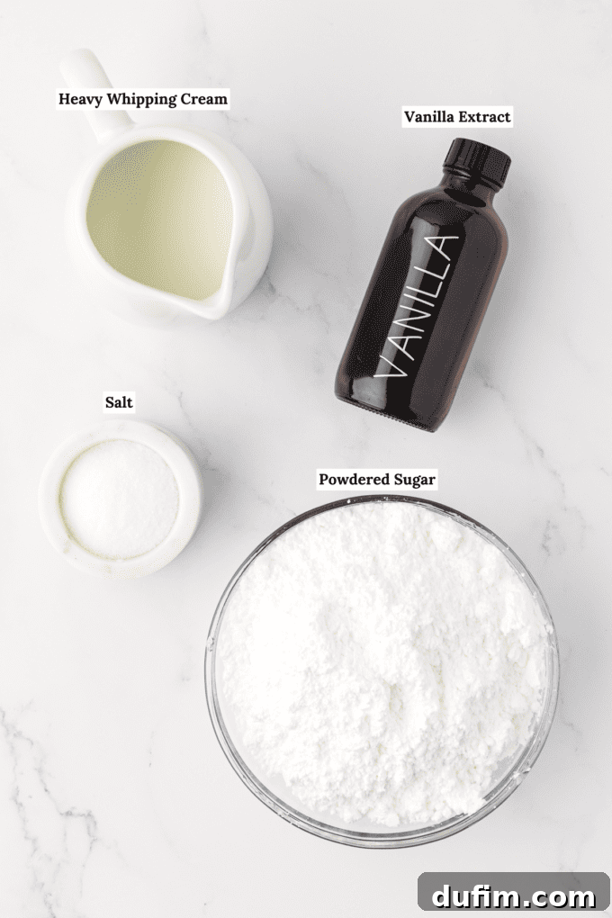overhead view of the ingredients for vanilla glaze including a white dish full of heavy whipping cream, a bottle of vanilla extract, a small white bowl of salt and a large glass bowl of powdered sugar