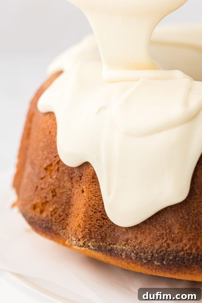 vanilla glaze dripping down the sides of a vanilla bundt cake