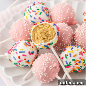 A white plate with a pile of cake pops, some light pink with white sprinkles and some white with rainbow sprinkles, with the cake pop on top missing one bite out of it