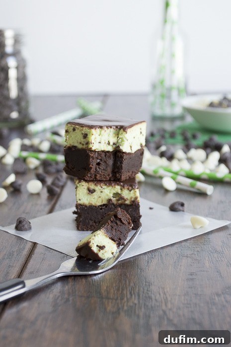 A final close-up image of a Mint Chip Mousse Brownie with a single bite taken out, revealing the soft, layered interior. The brownie is garnished with fresh mint leaves and chocolate shavings, emphasizing its gourmet appeal.