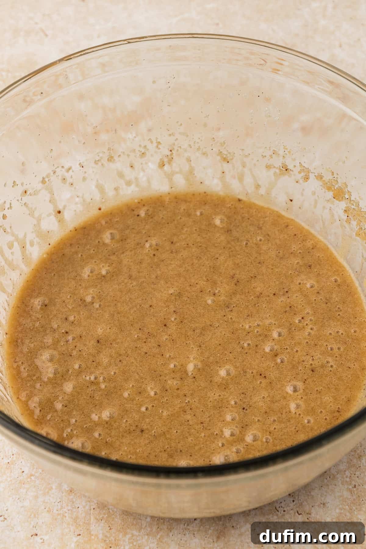 The perfectly blended wet ingredients for pizookie, a harmonious mixture in a clear glass bowl, showcasing a rich, creamy consistency.