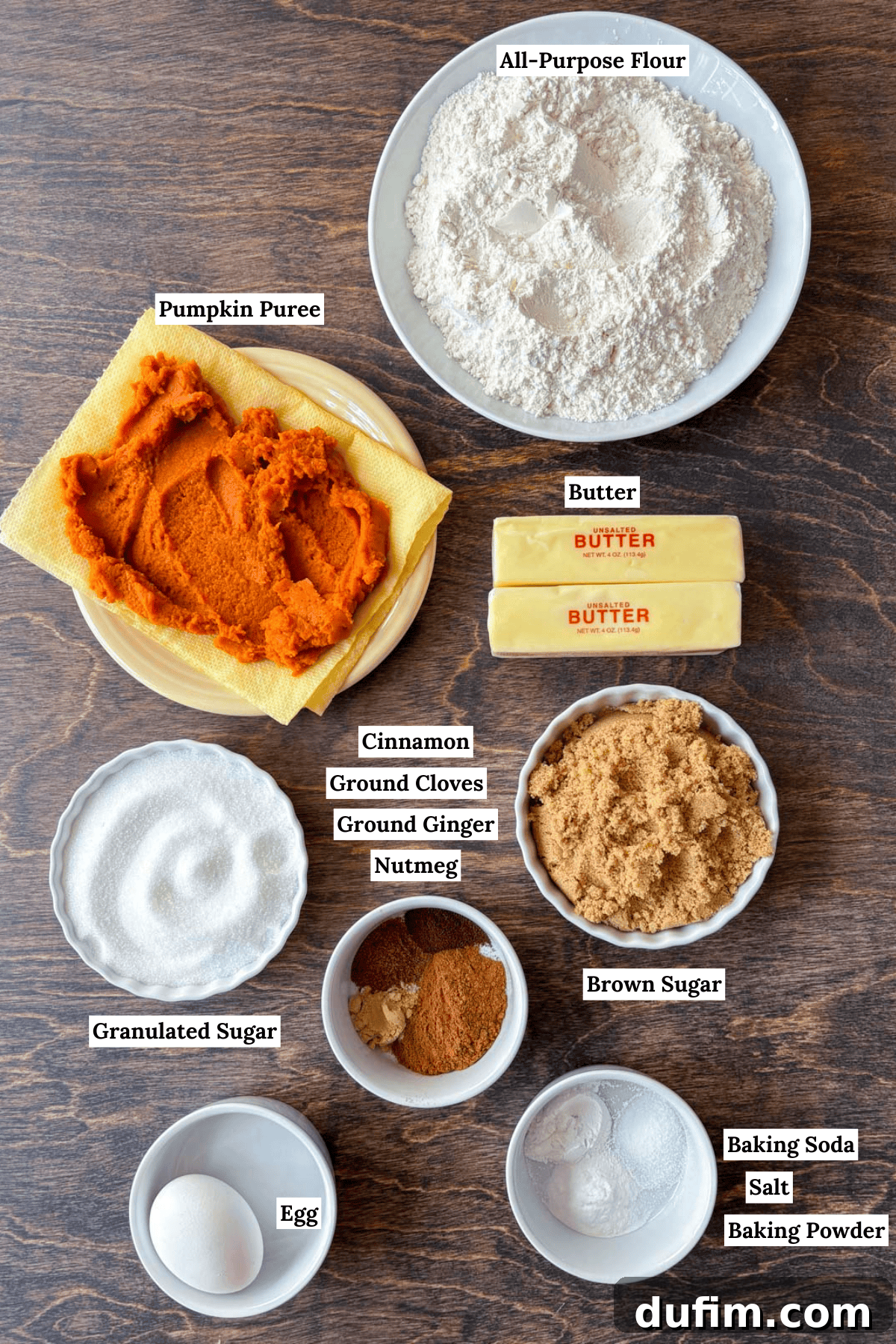 Cozy Autumn Pumpkin Spice Cookies 4 over head view of the ingredients for pumpkin cookies including all-purpose flour, pumpkin puree, butter, granulated sugar, cinnamon, ground cloves, ground ginger, nutmeg, brown sugar, egg, baking soda, salt and baking powder