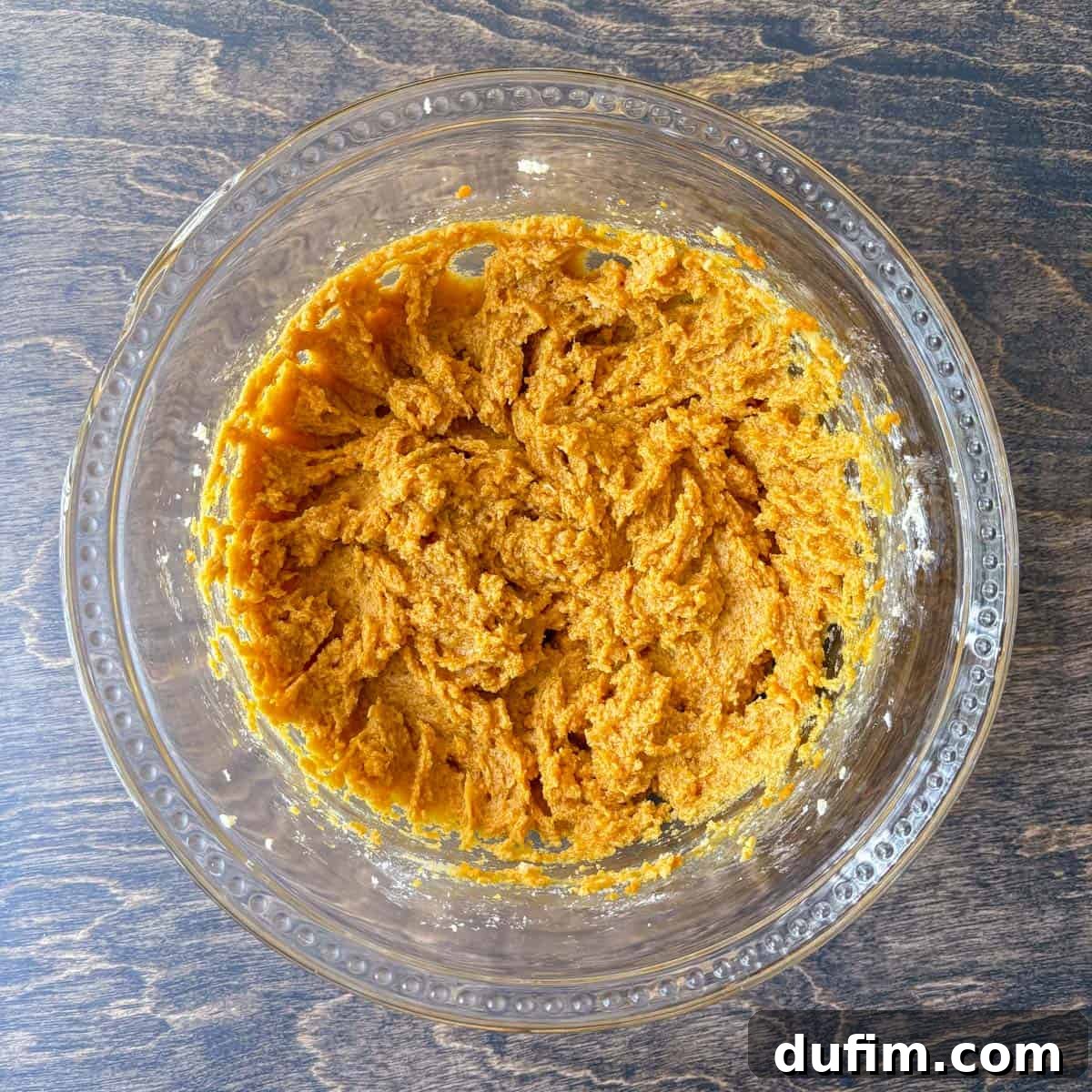 Cozy Autumn Pumpkin Spice Cookies 9 pumpkin cookie dough mixture in a clear glass bowl