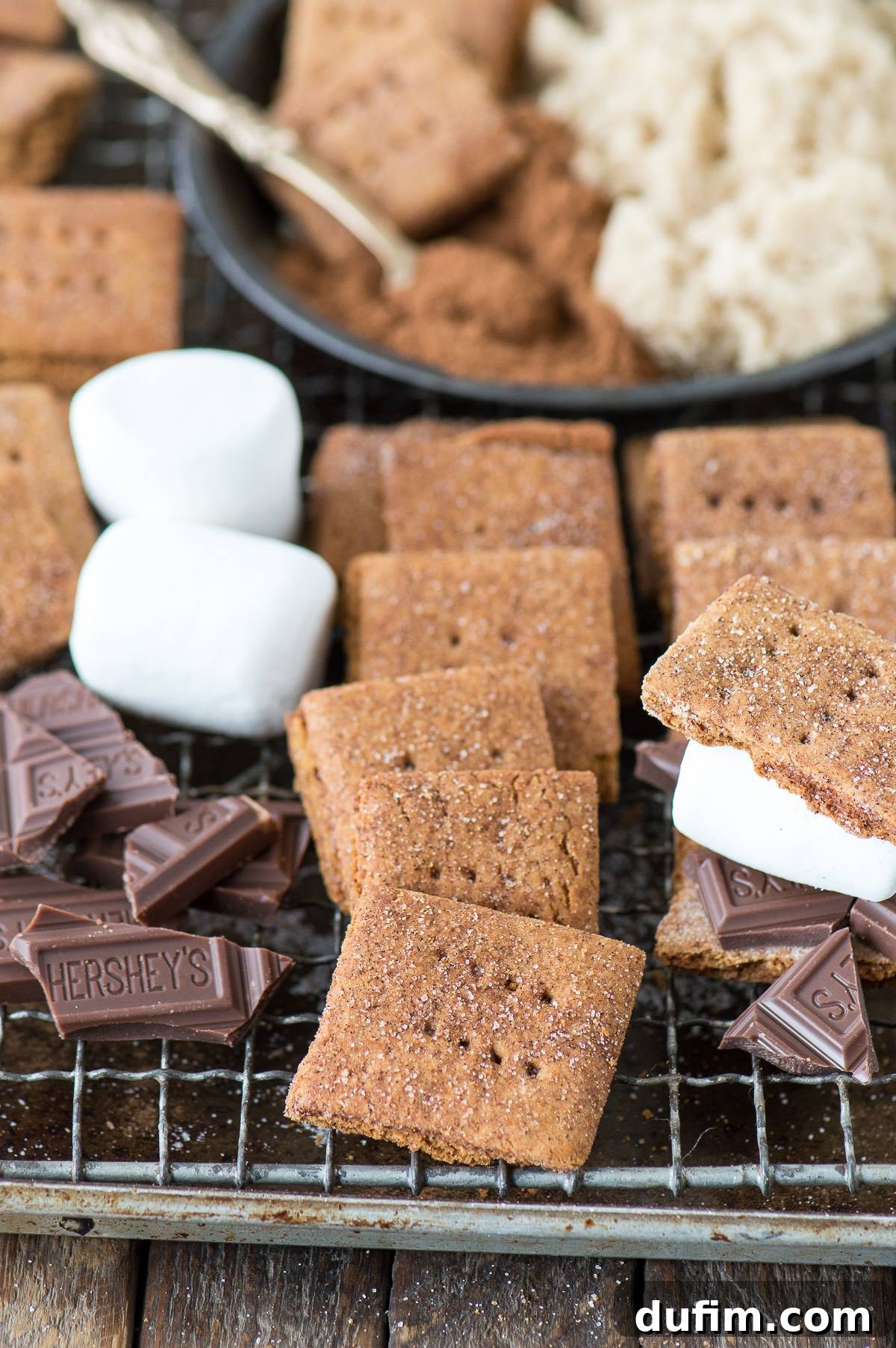 Close-up of perfectly scored and pricked homemade brown sugar cinnamon graham crackers, sprinkled generously with cinnamon sugar, ready for baking.