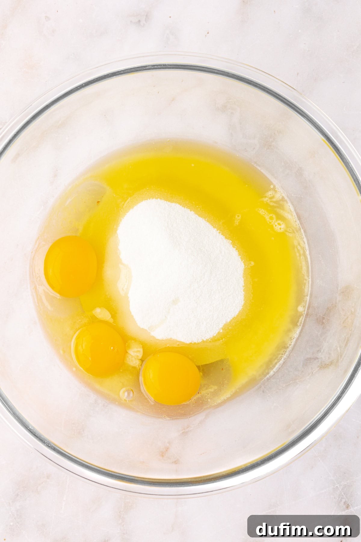 eggs, sugar and butter in a clear glass mixing bowl