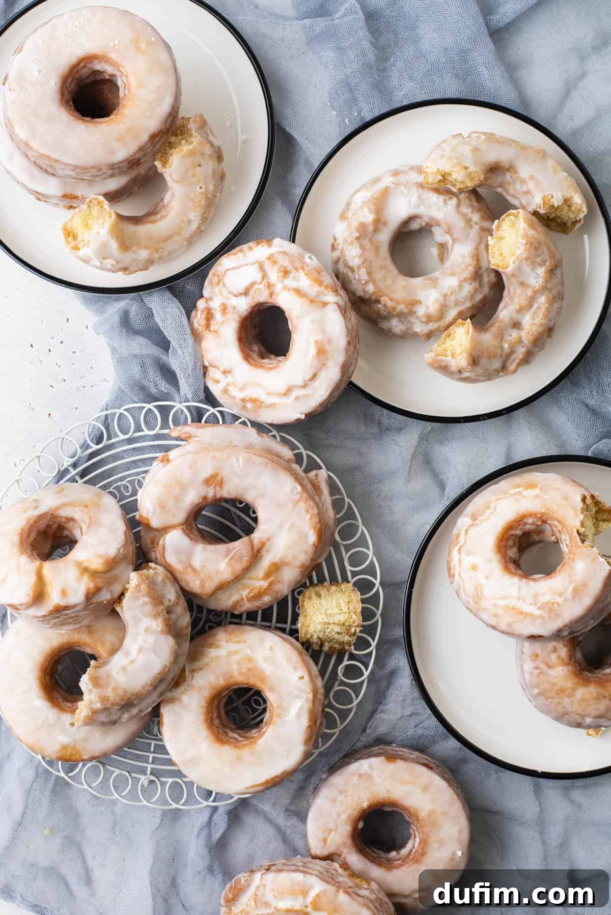 Effortless Donut Glaze Perfection 15 Several small plates adorned with stacks of old-fashioned donuts, each generously covered in a shimmering donut glaze.