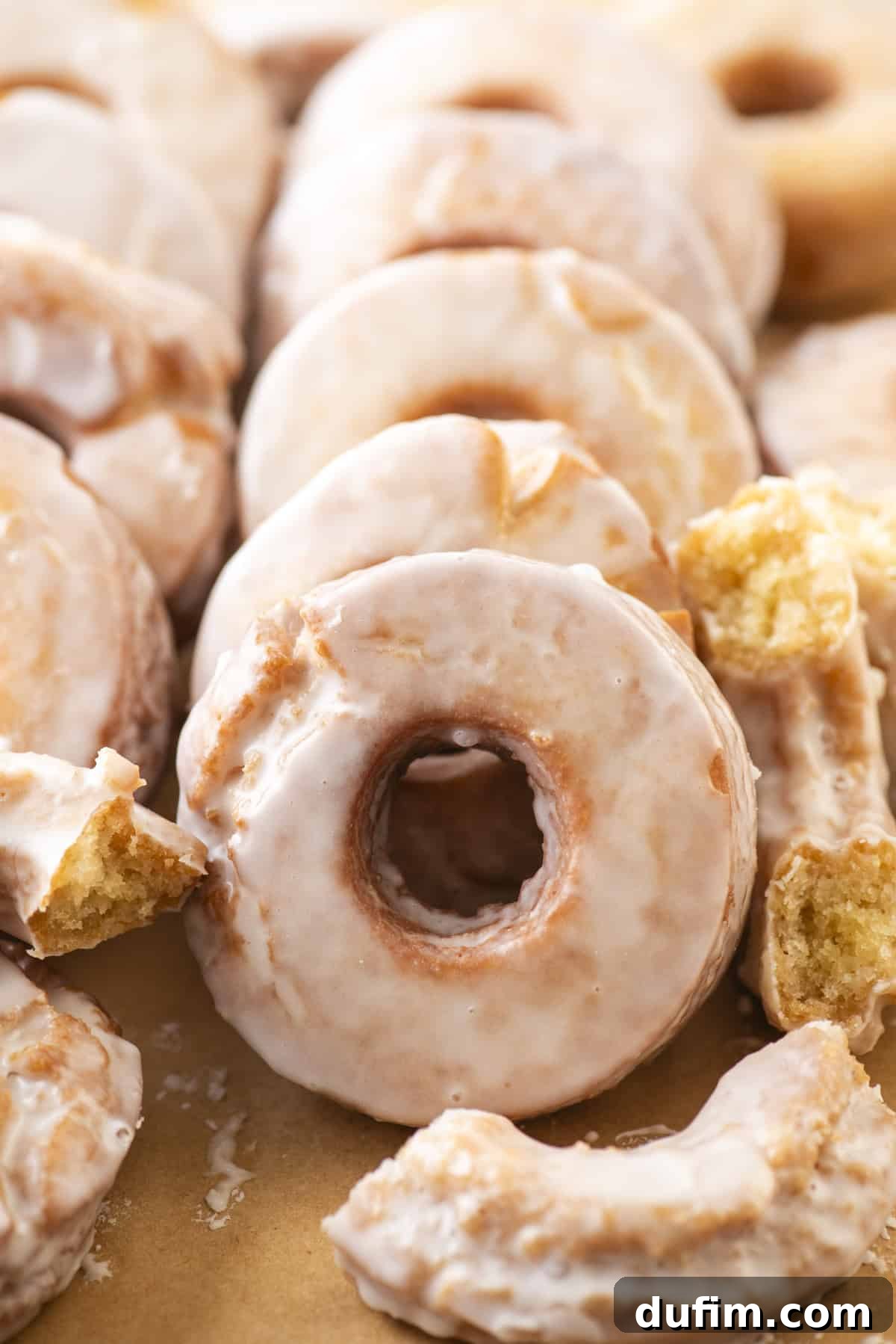 Effortless Donut Glaze Perfection 16 An array of old-fashioned donuts coated in a beautiful donut glaze, stacked and scattered for a mouth-watering display.