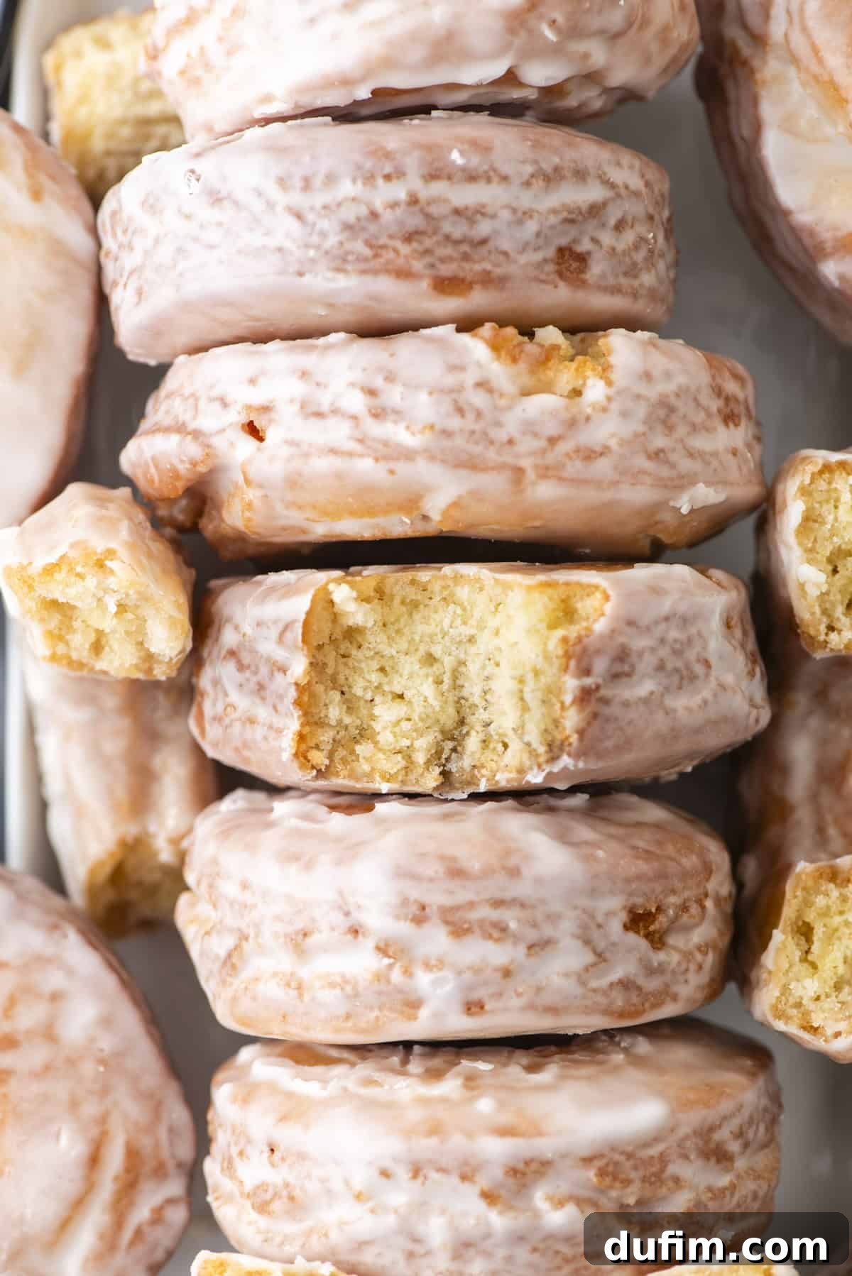 Effortless Donut Glaze Perfection 3 Overhead shot of a delicious row of freshly glazed donuts, perfectly set and ready to eat.