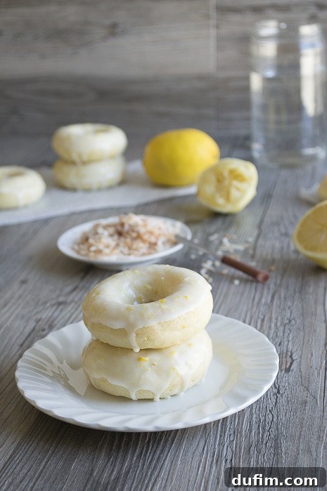Plate of decorative Lemon Coconut Donuts, garnished and ready to serve
