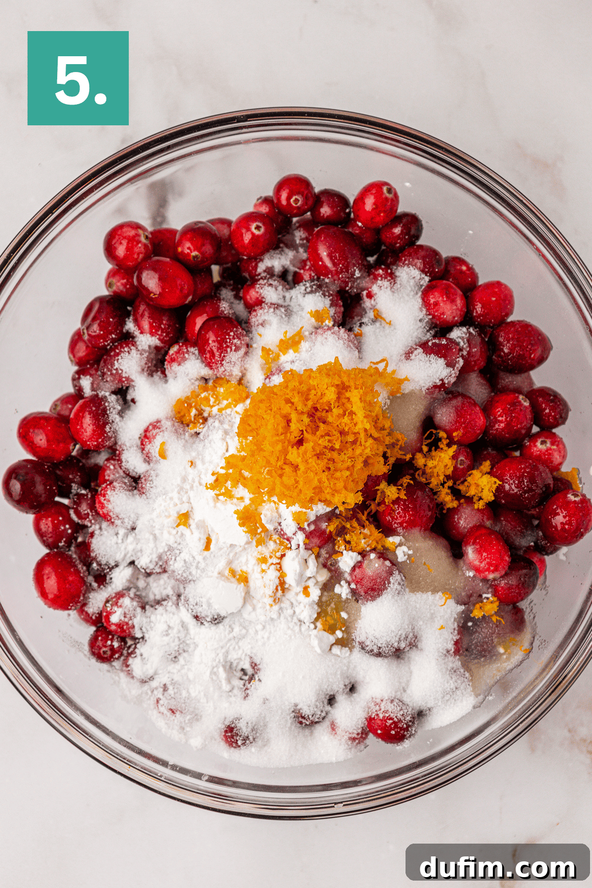 Cranberries, granulated sugar, cornstarch, orange zest, and orange juice in a large glass bowl