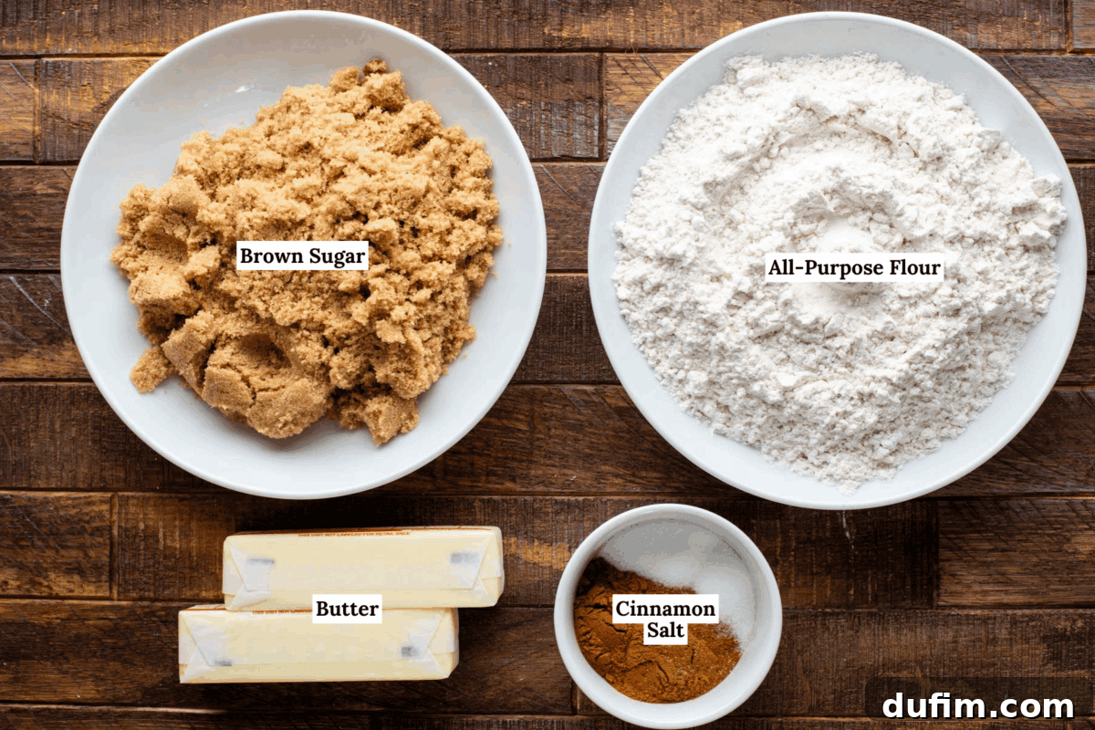 Four primary baking ingredients for the crumb topping, neatly arranged on a wooden surface: a bowl filled with rich brown sugar, another bowl with all-purpose flour, two sticks of unsalted butter, and a small bowl containing ground cinnamon and salt. Each item is clearly presented, ready for combination.