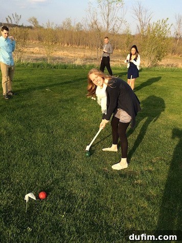 Playing croquet at a friend's elegant outdoor wedding celebration