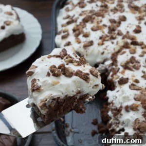 The ultimate Candy Bar Cake, a fantastic way to use up leftover Halloween candy.