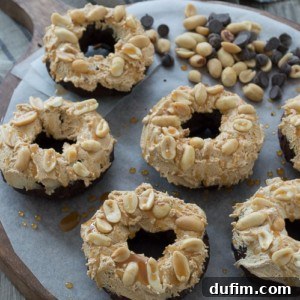The finished Snickers Donuts, ready to be served, capturing the delicious details of the toppings.