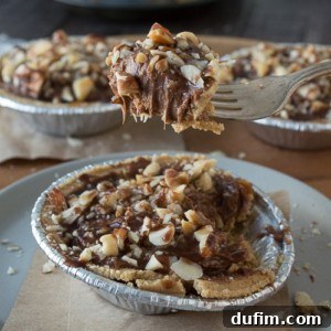 No bake mini pies with two layers of mixed nuts and a rich chocolate filling, topped with chocolate and caramel!