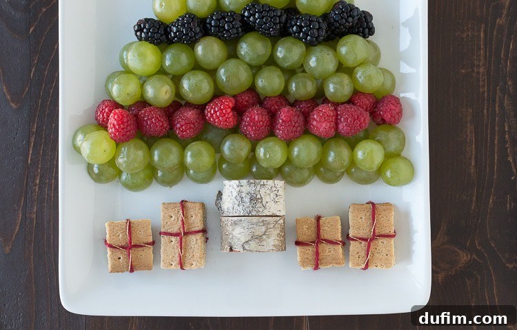 The finished Christmas tree fruit platter ready to be served, a healthy and vibrant addition to any holiday table.