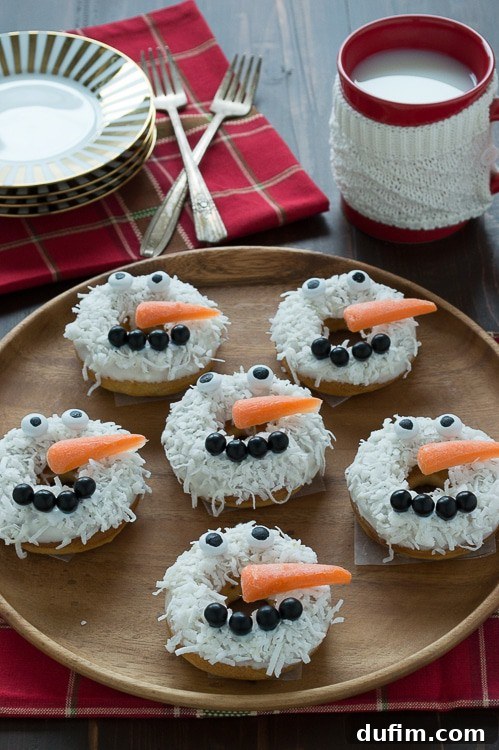 Close-up of baked caramel coconut snowmen donuts, showcasing their adorable features and festive appeal.