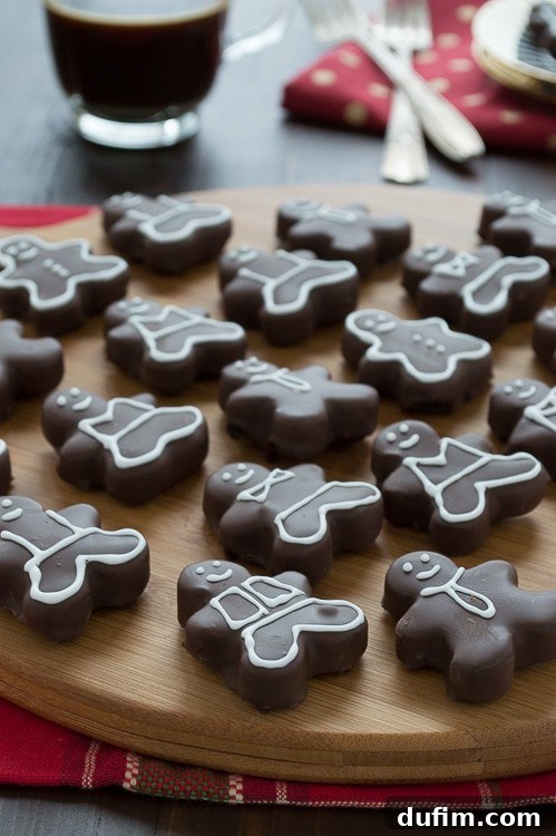 Delicious gingerbread men shaped Oreo balls, beautifully decorated with white icing, perfect for Christmas festivities.