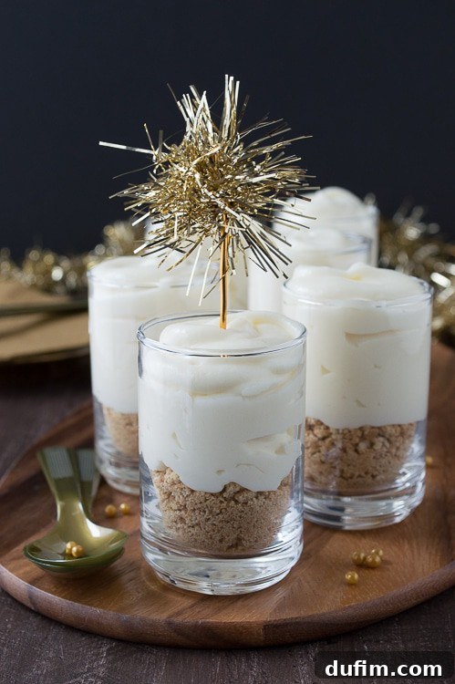 Make these fancy and easy white chocolate champagne cheesecake shooters for New Years Eve! I LOVE the gold tinsel toppers!